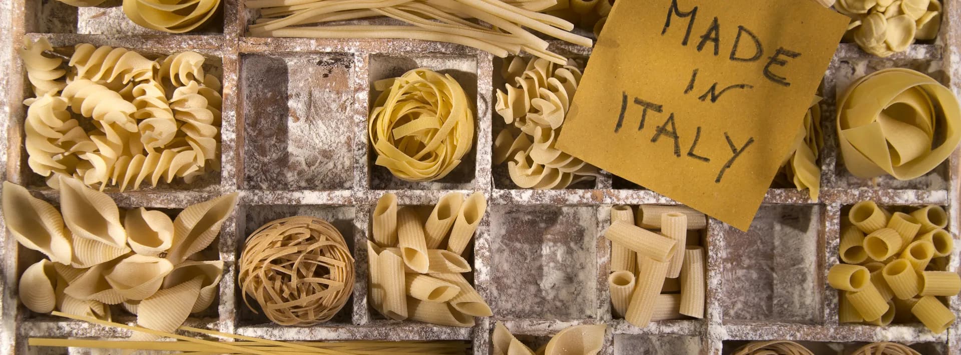 decorative arrangement of pasta varieties in a box with a sign that says Made in Italy