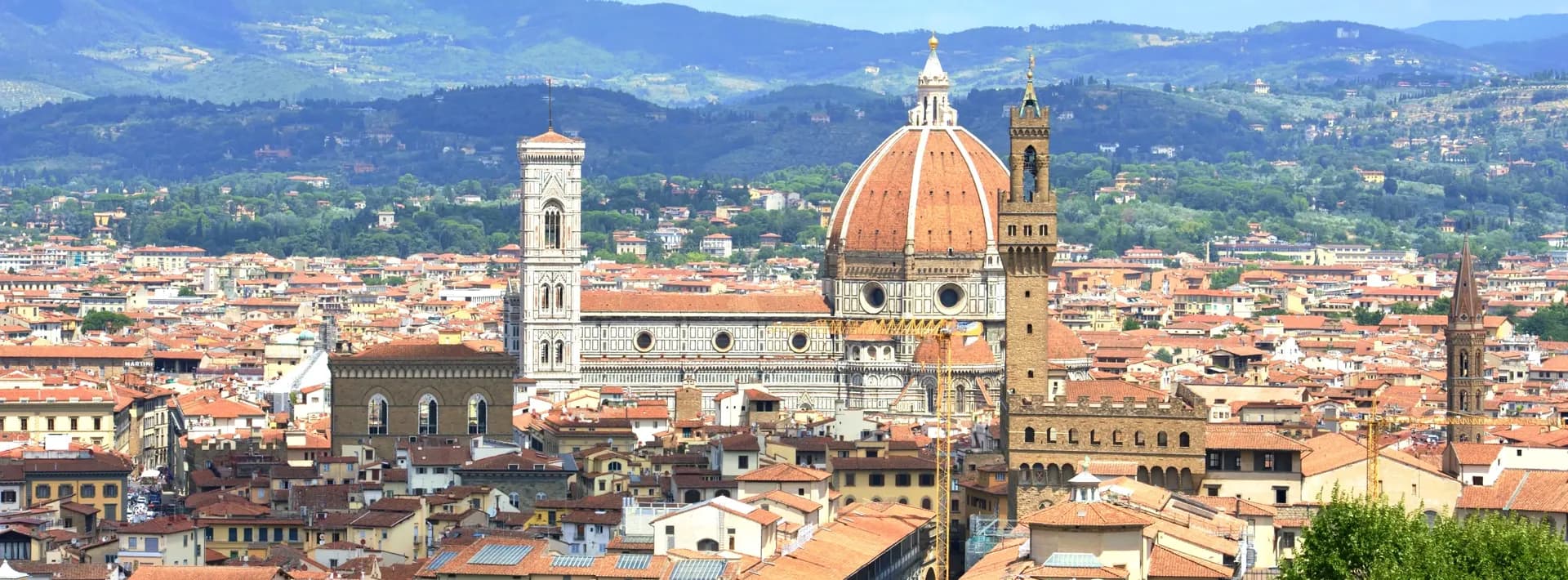 The cityscape of Florence, Italy with mountains in the background