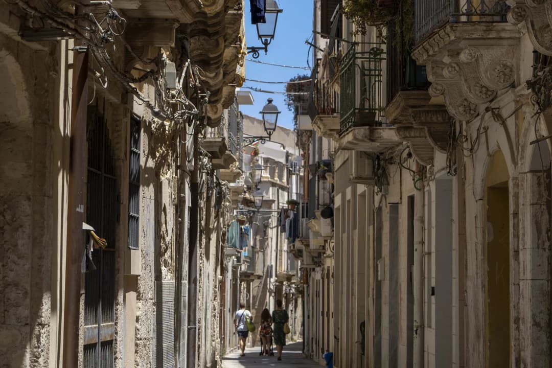 a narrow, winding street on the Island of Ortigia in Syracuse