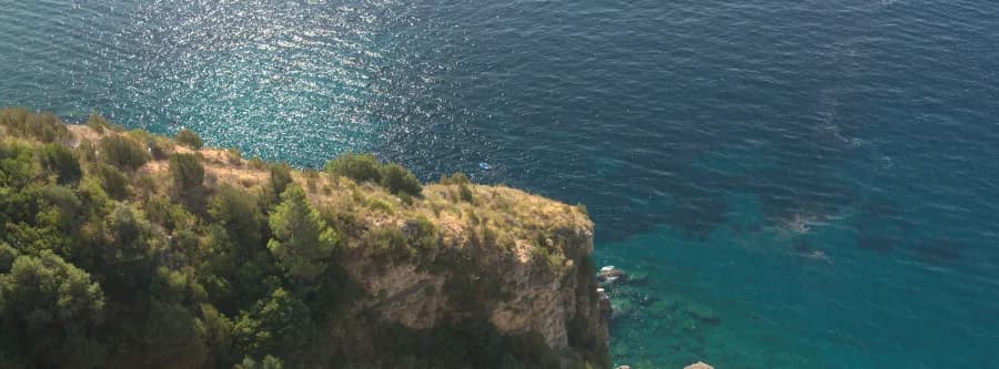 view of a cliff and aquamarine waters along the Amalfi Coast