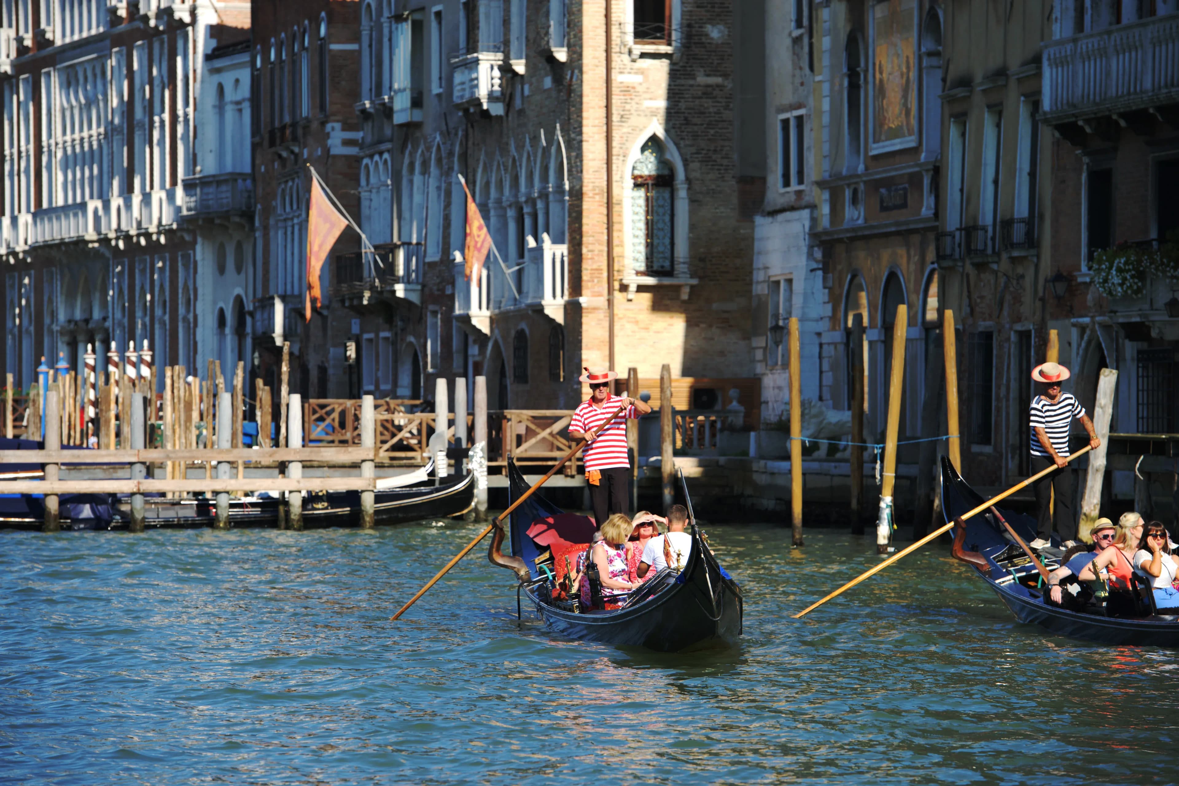 Gondolas gliding along the Grand Canal in Venice, Italy