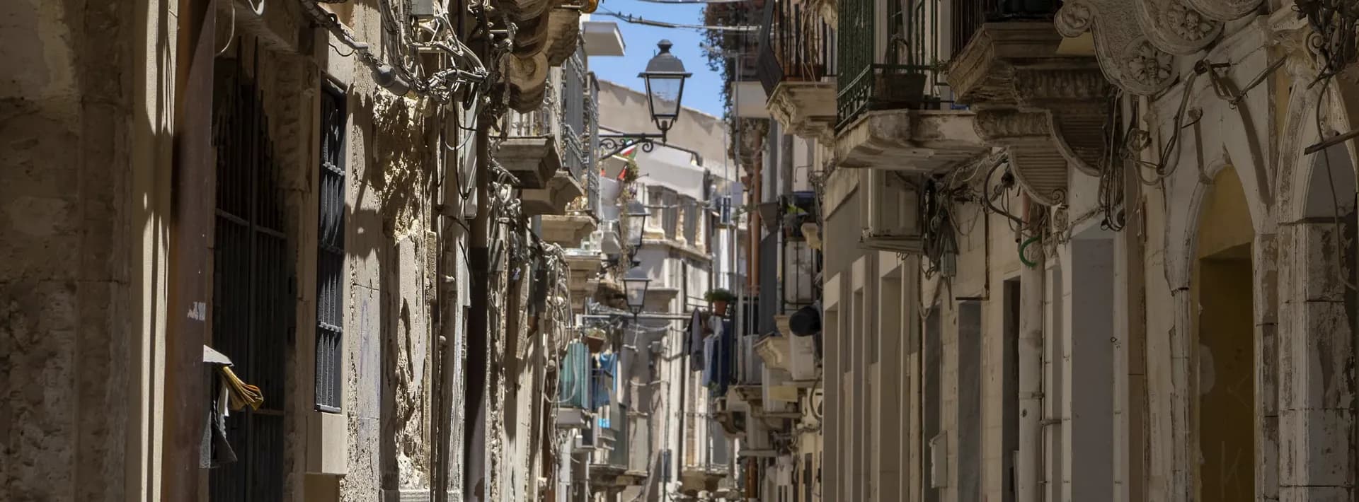 a narrow, winding street on the Island of Ortigia in Syracuse