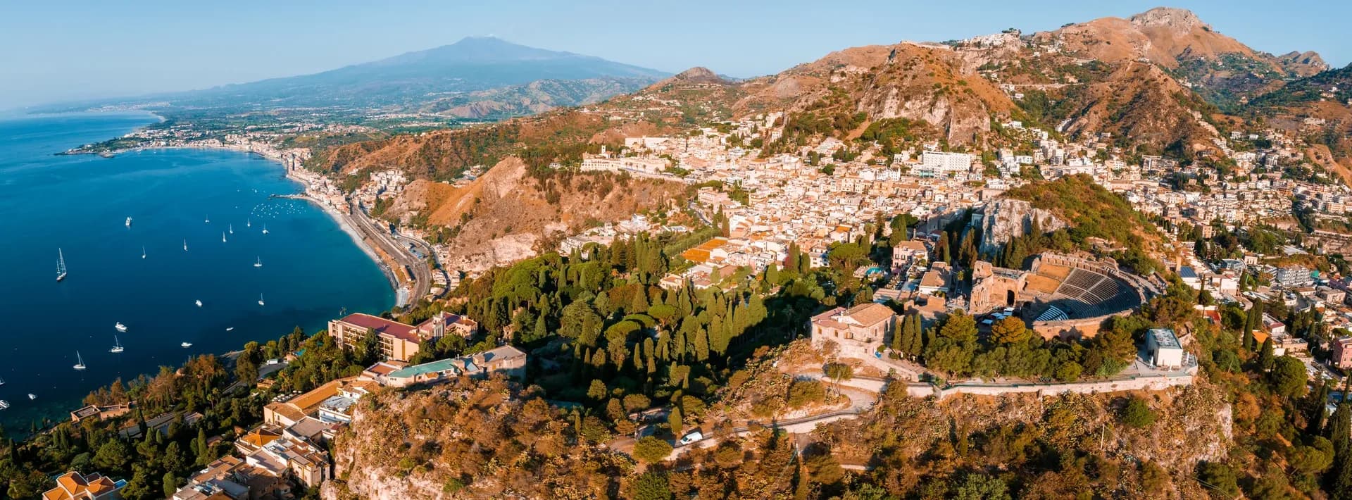 an aerial view of Isola Bella in Taormina, Italy