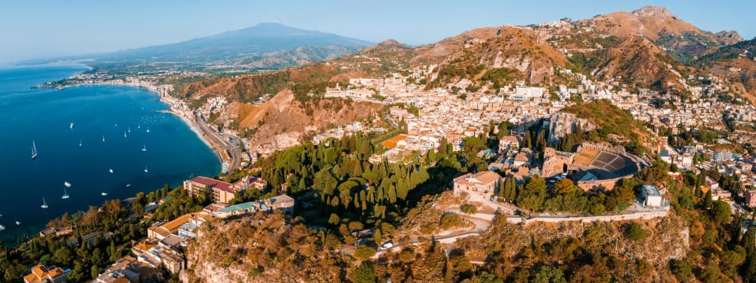 an aerial view of Isola Bella in Taormina, Italy