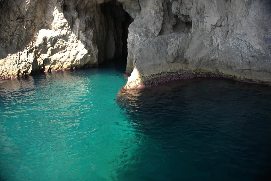 Capri's aquamarine waters and entrance to one of her many caves