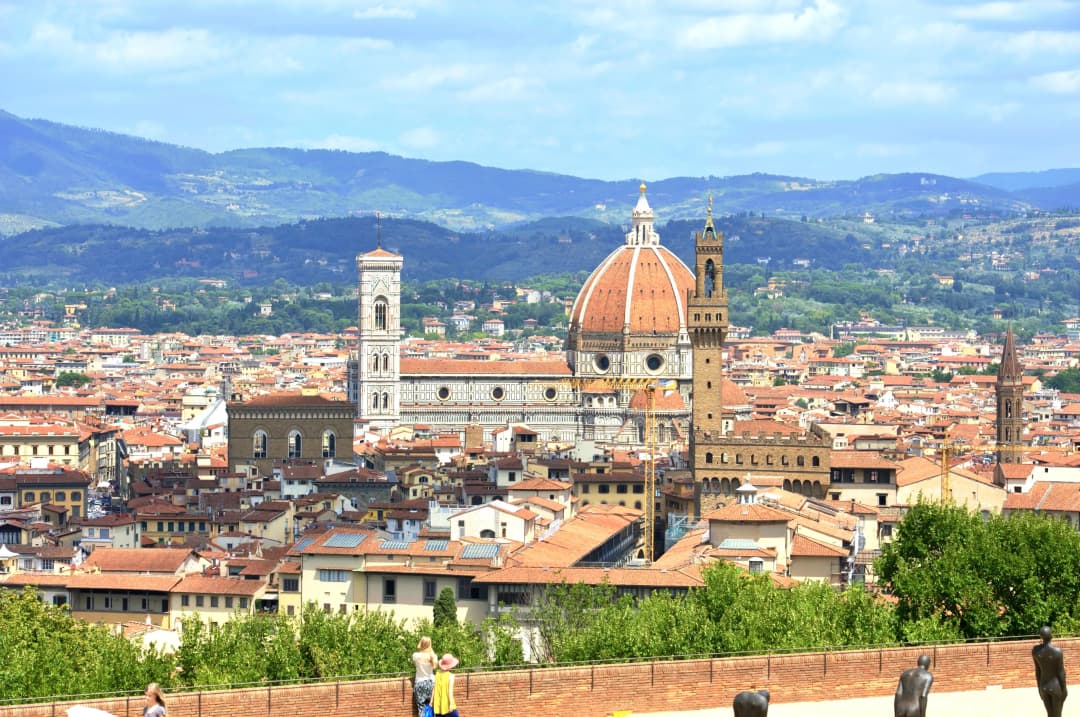 The cityscape of Florence, Italy with mountains in the background
