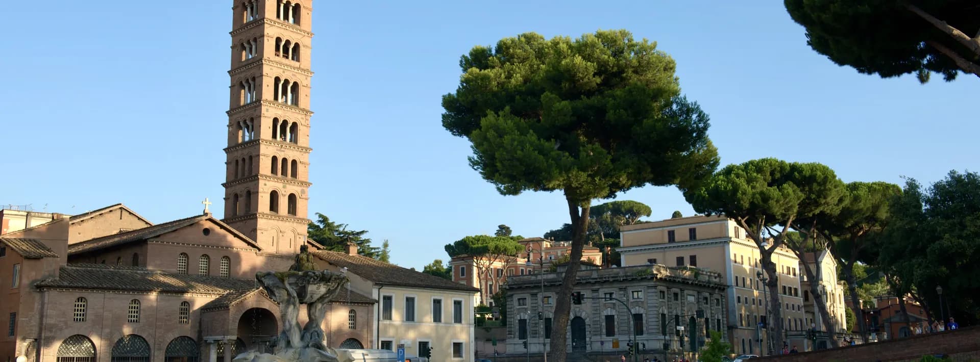 The Santa Maria Cosmedin and Fontana dei Tritoni in Rome just before sunset