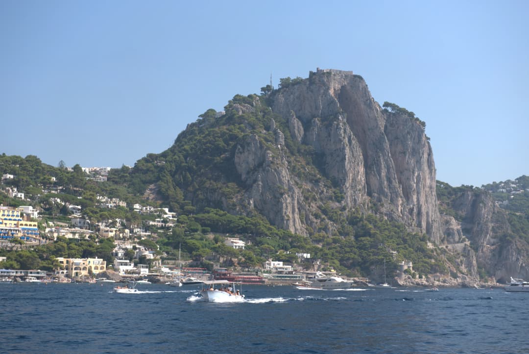 view of city and cliffs in Capri seen from the boat tour